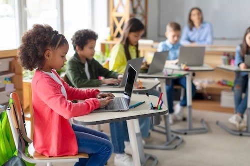 Students using laptops in a modern classroom